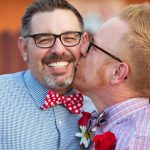 Smiling Man Kissed By Spouse