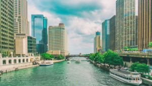 Boat on the Chicago River passing downtown high-rise buildings