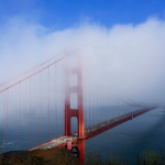 Golden Gate Bridge in San Francisco under a blue sky with white clouds