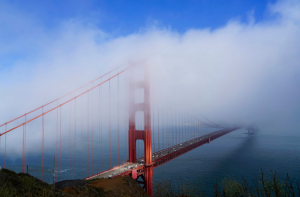 Golden Gate Bridge in San Francisco under a blue sky with white clouds
